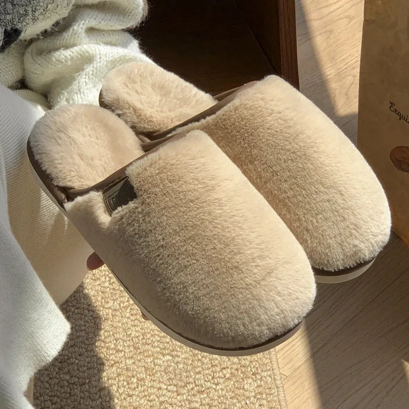 Pair of solid-colour plush house slippers with car stitching detail on the PVC upper.