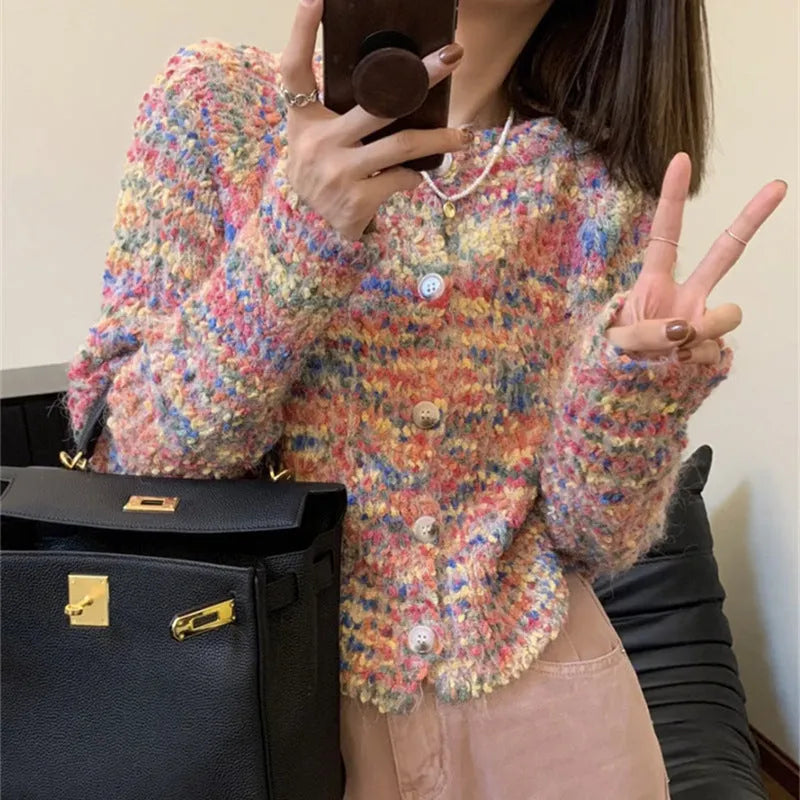 Pink and green rainbow pattern knitted cardigan on a hanger, showing slim fit and regular sleeves.