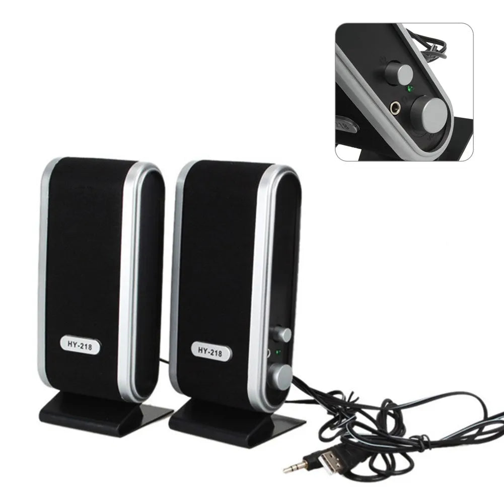 A black notebook mini speaker with a USB cable for computer audio.