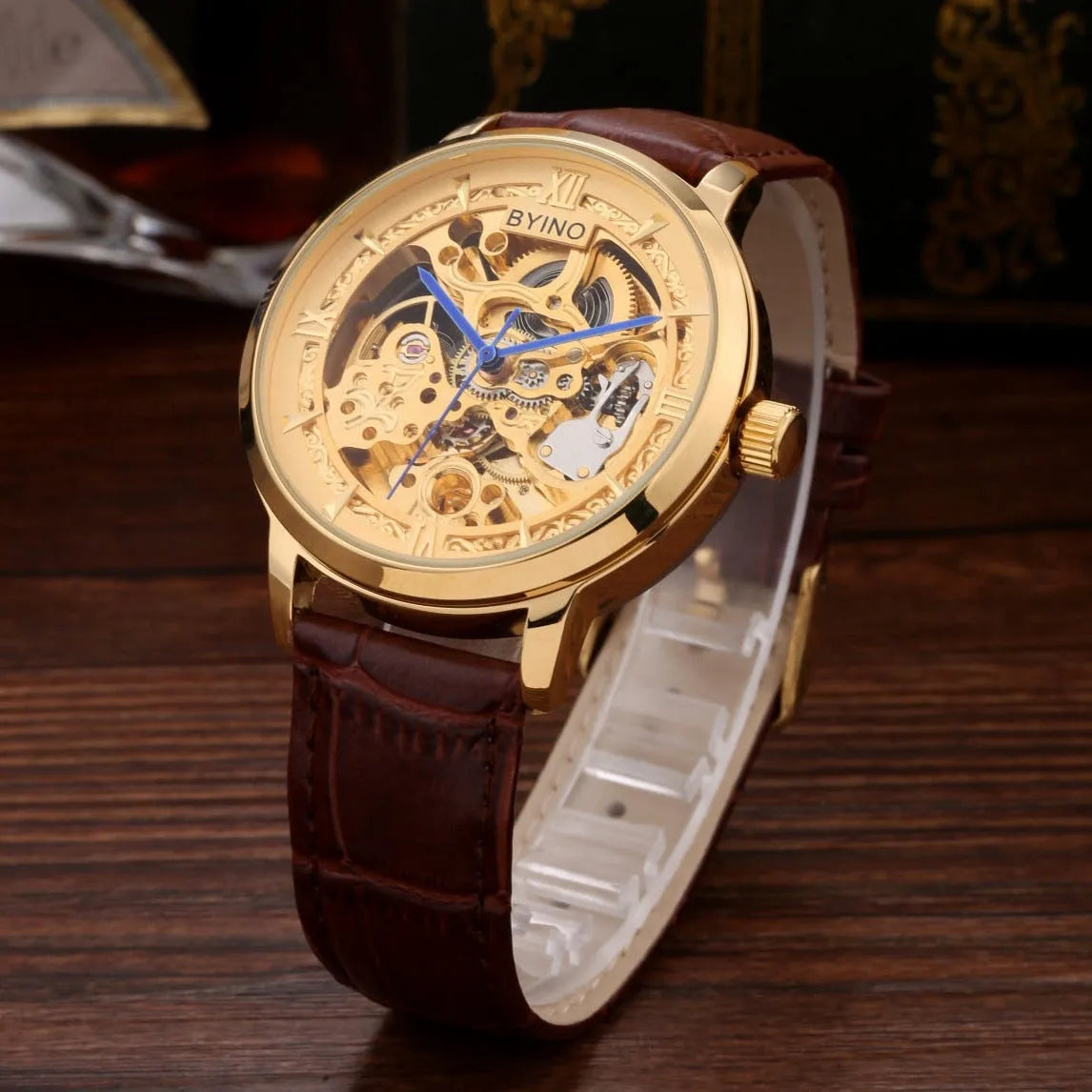 Men's automatic mechanical watch with hollow skeleton dial, leather strap, gold-tone casual design, waterproof