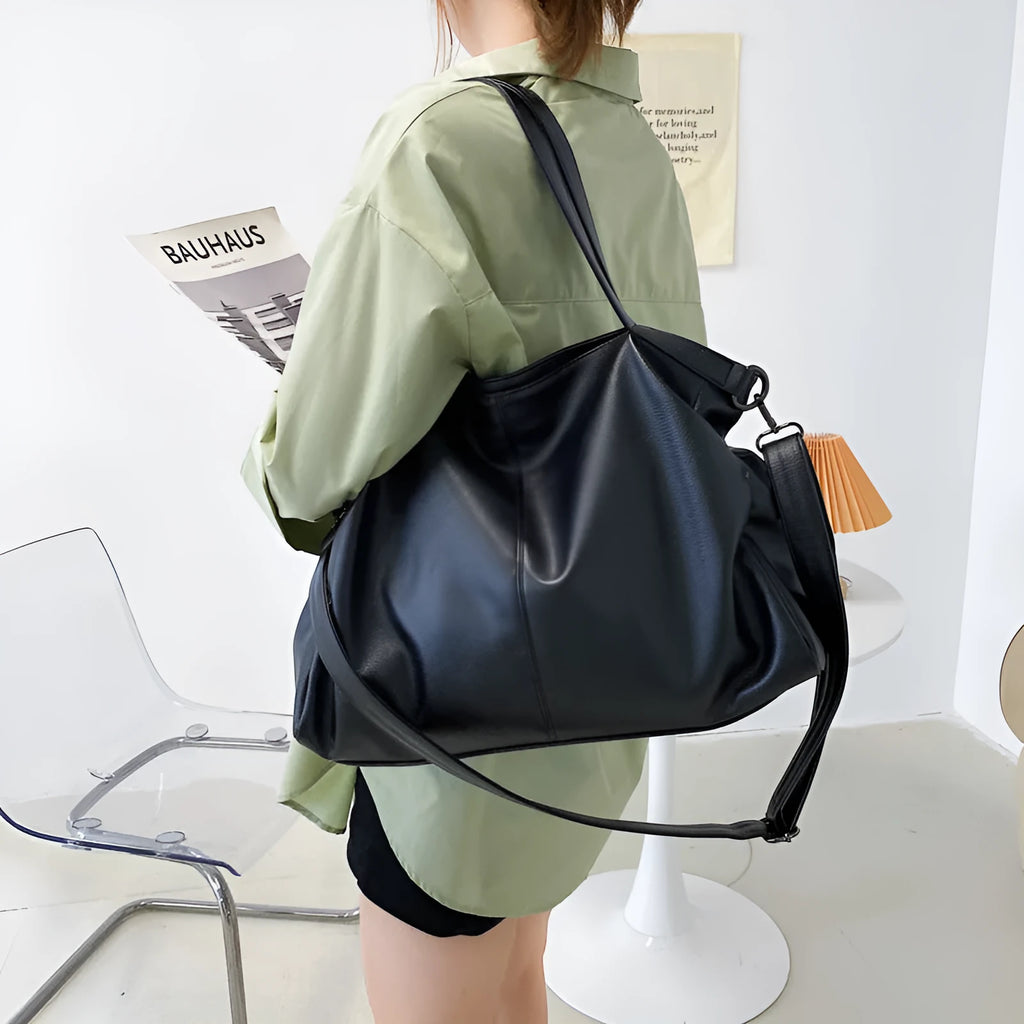 Large soft surface PU messenger tote bag in black with adjustable shoulder strap and zipper opening.