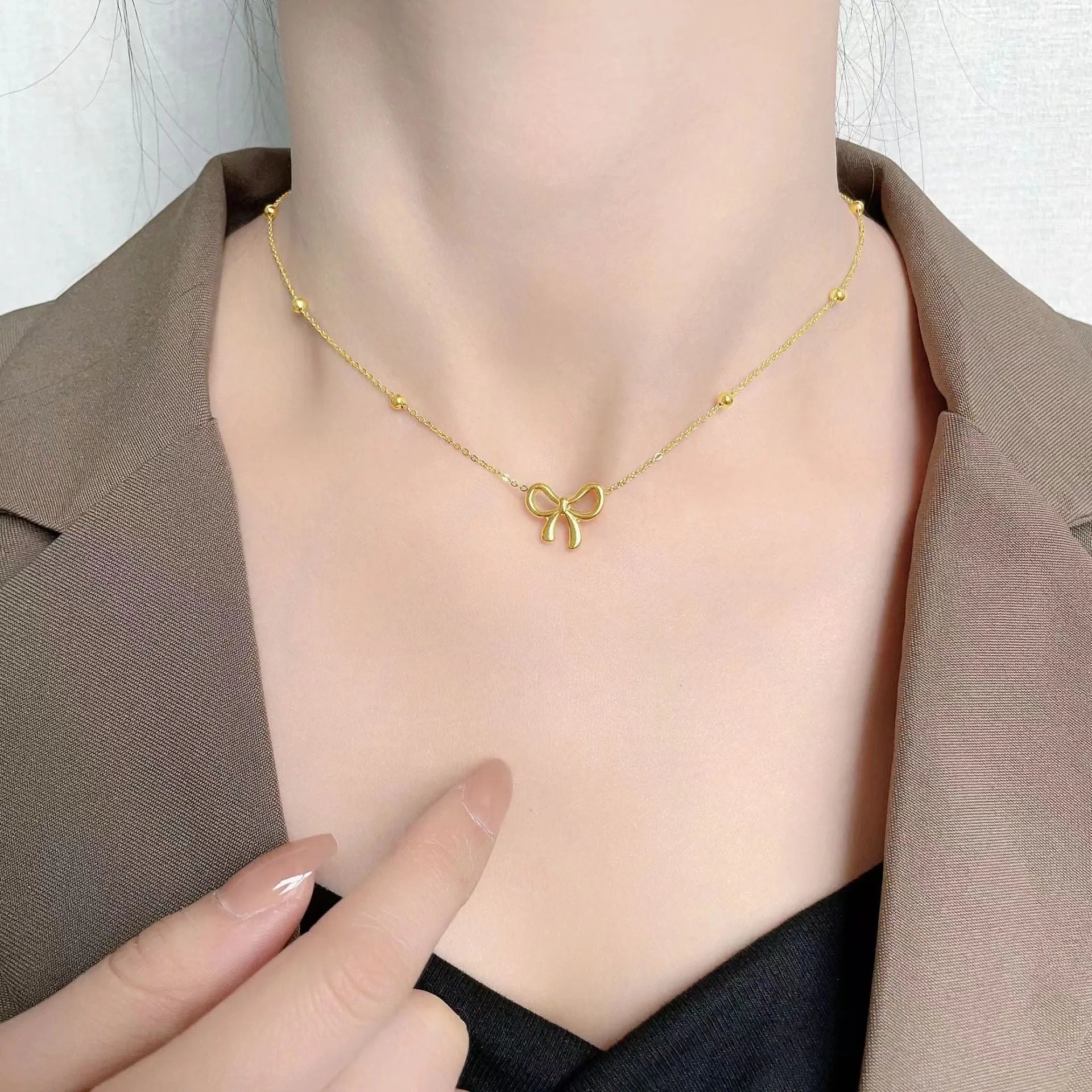 Gold electroplated bow necklace on titanium steel chain with adjustable 41-50cm length