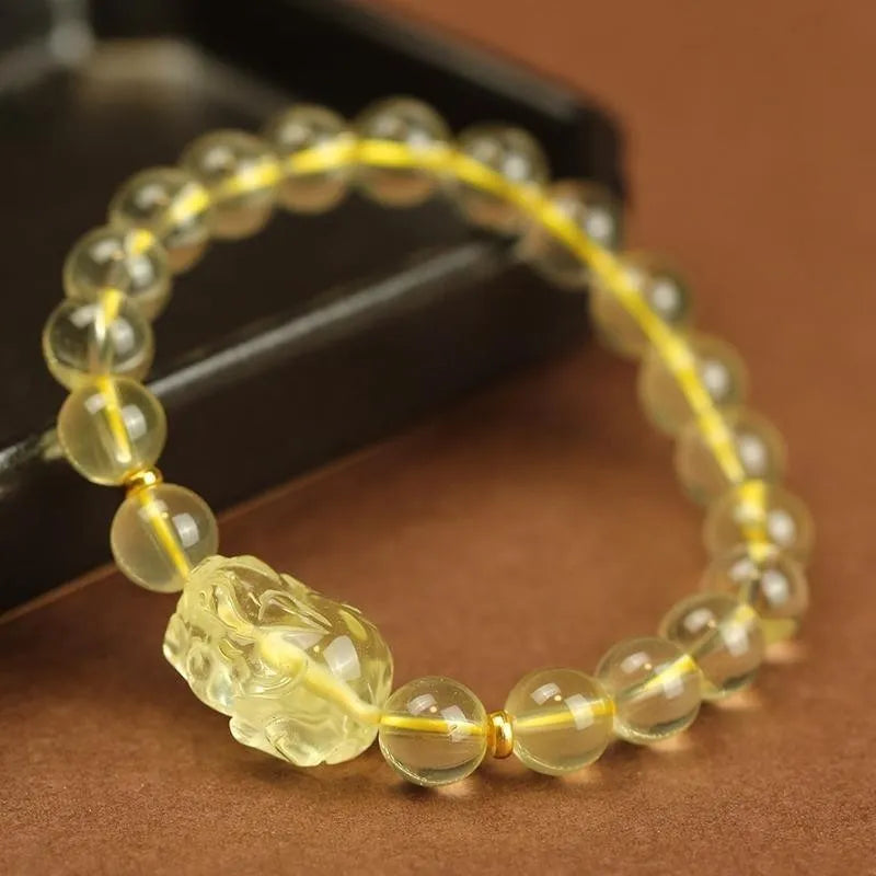 Yellow leather adjustable bracelet with a citrine Pi Xiu crystal charm in Chinese simple style.