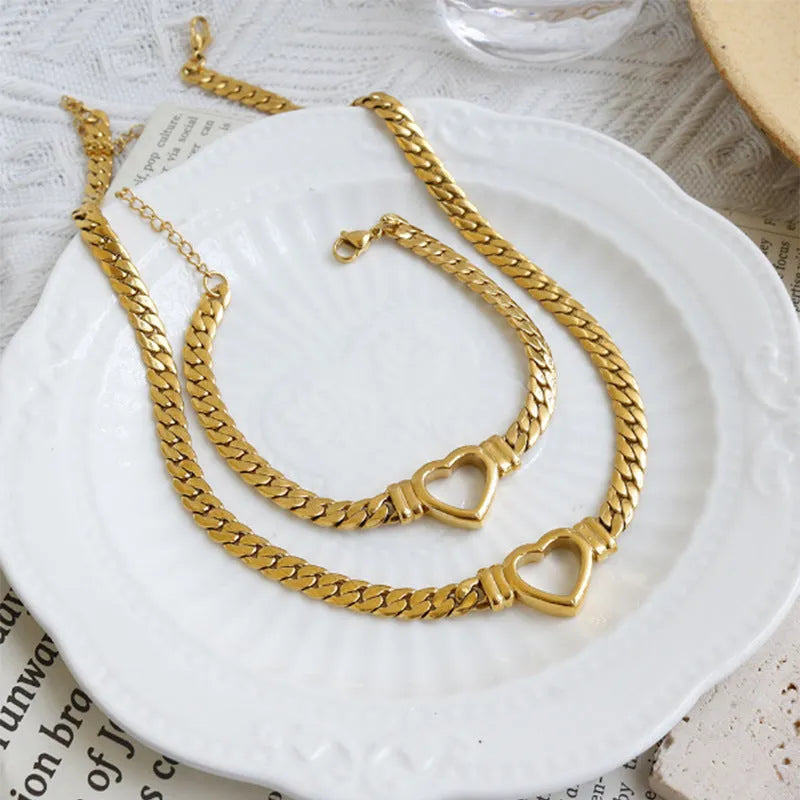 Gold titanium steel personalised love chain necklace and bracelet set with Cuban links and heart shape on white background