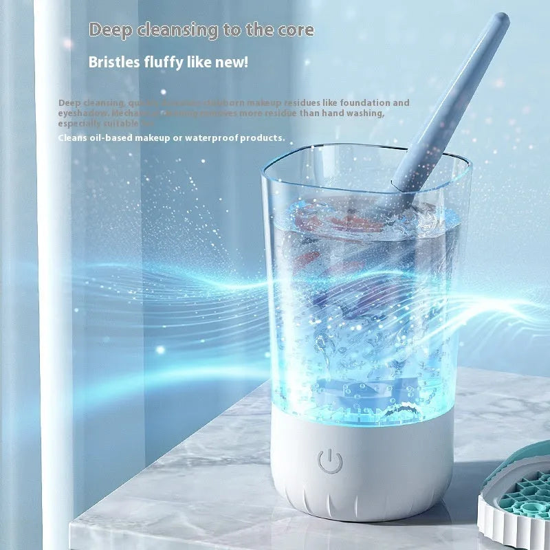 White plastic rechargeable electric cleaning brush for makeup brushes with data cable.