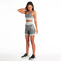 Women's seamless shorts fitness suit in charcoal with fitted top and shorts, three-quarter view on model