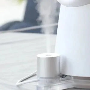 White desktop bladeless fan with USB humidification, 3 speed settings, and LED light on a desk