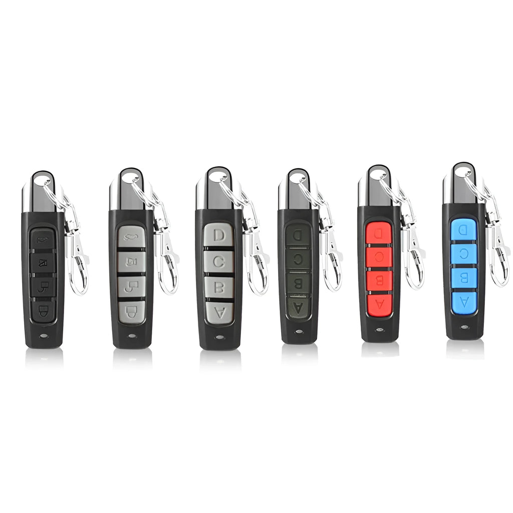 A compact black rolling door remote control showing buttons for copying and testing signals.