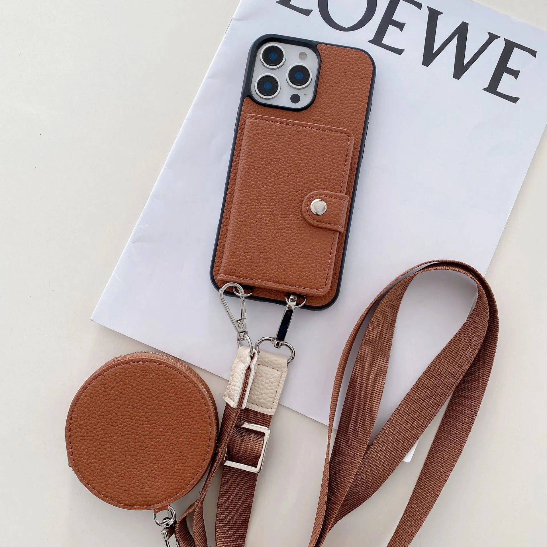 Black PC leather phone case with card slot and attached lanyard for iPhone, shown alongside credit cards.