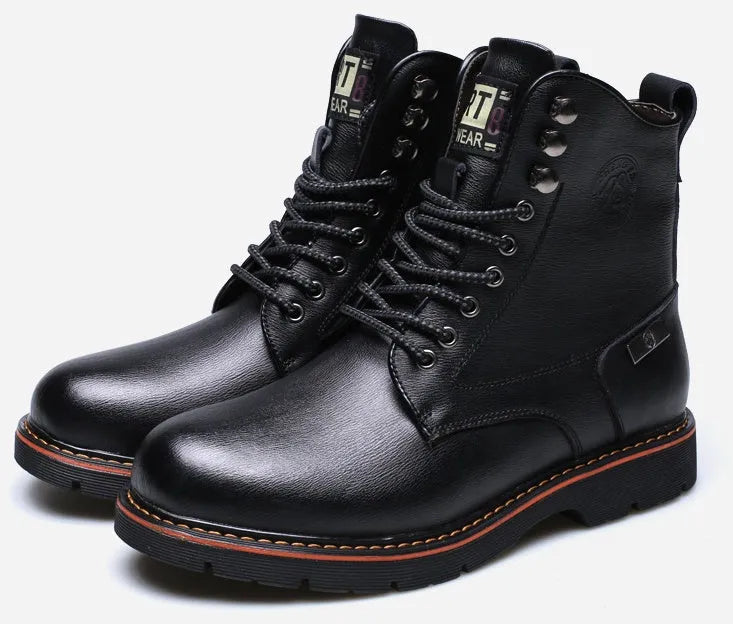 Men's brown embossed leather Martin boots with mid-top cut, round toe, thick heel, and front strap on a wooden floor