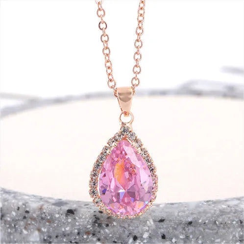 Women's water drop shaped pink necklace with rose gold rhinestone geometric detailing on alloy chain