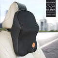 Black memory foam car headrest pillow and matching lumbar support pillow on a car seat.
