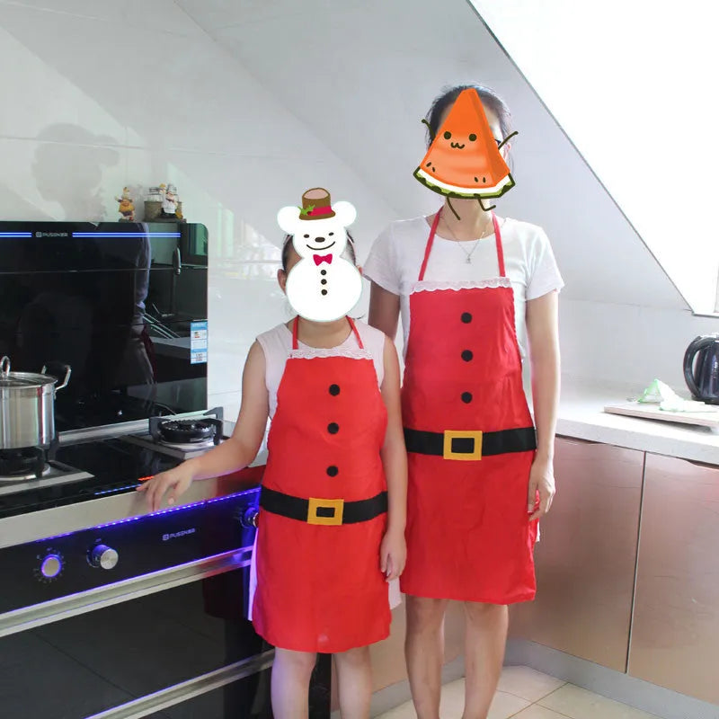 Red polyester Christmas apron shown in adult and children's sizes on a kitchen background