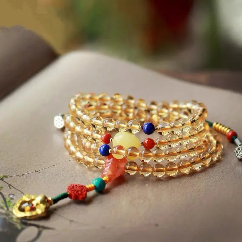 Close-up of a yellow Brazilian citrine bracelet with small 1mm beads on a black filament cord.