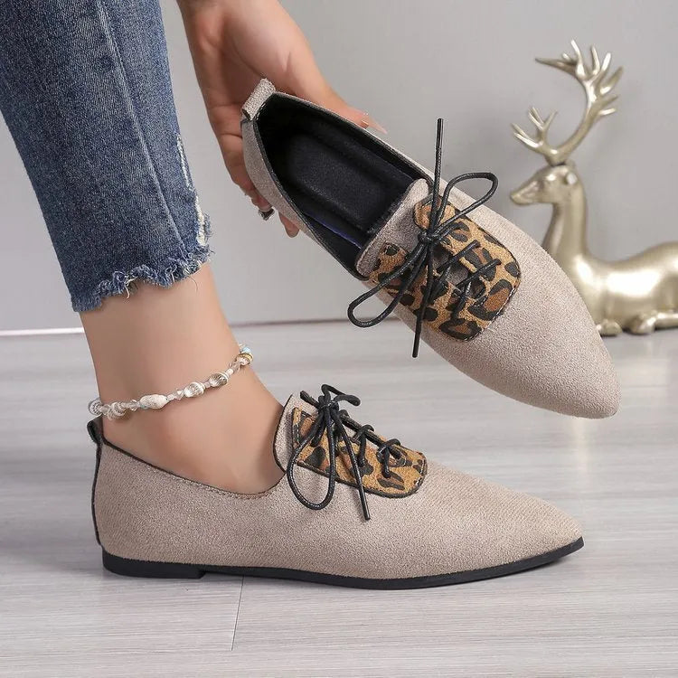 Beige leopard print pointed toe court shoes for women with a low block heel, shown in a plus size fit.
