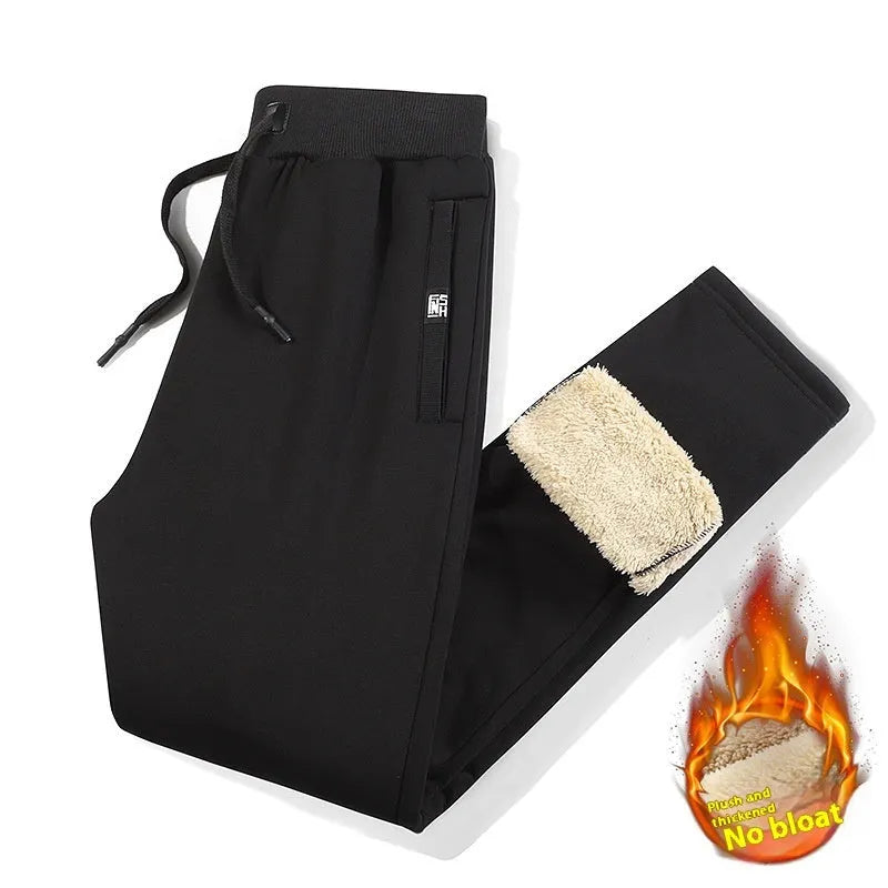 Man wearing grey fleece-lined cotton track pants with an elastic mid waist.