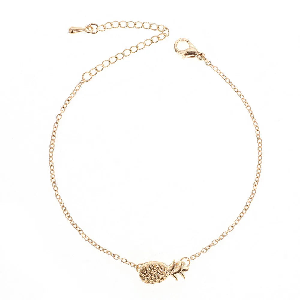 Gold or silver alloy bracelet featuring a pineapple charm, from the XINGX women's jewellery series.