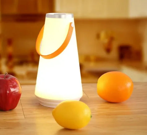 White rechargeable LED bedside lamp with adjustable brightness on wooden table