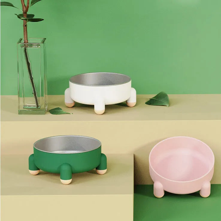 Green ceramic-coated stainless steel pet bowl with non-slip base and raised high-foot design.