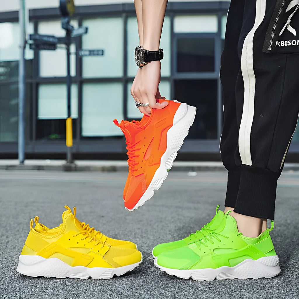Men's fluorescent red mesh casual trainers with cross shoulder straps and white laces on a flat MD sole.