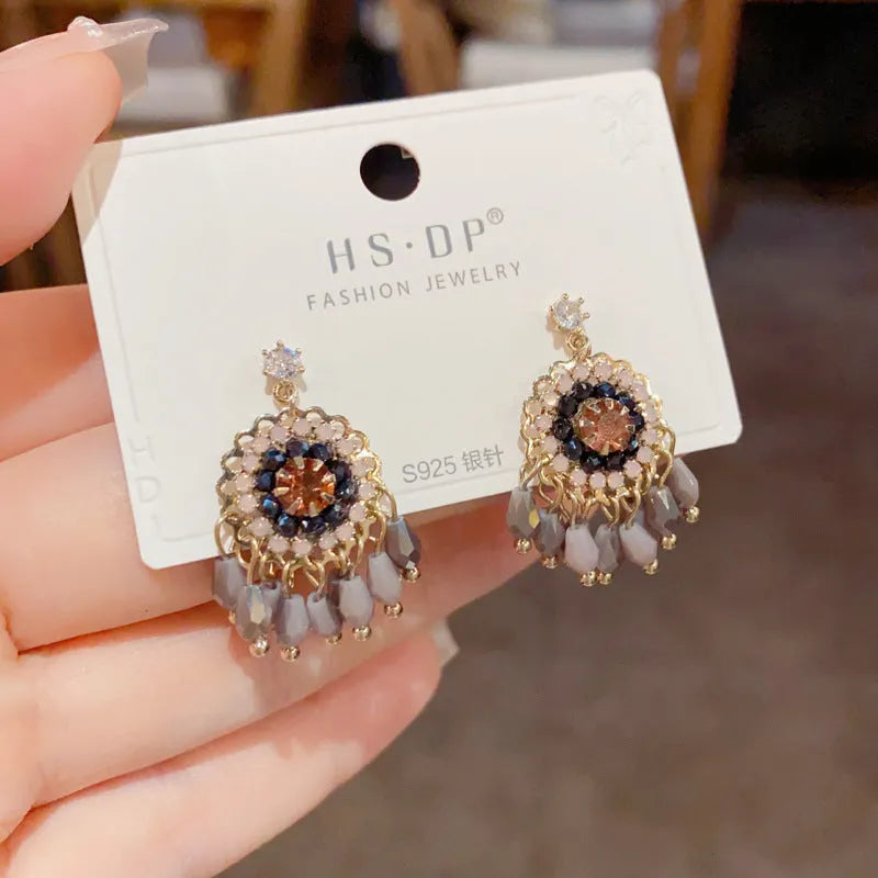 Women's round crystal tassel earrings with embedded diamonds in blue and purple geometric designs