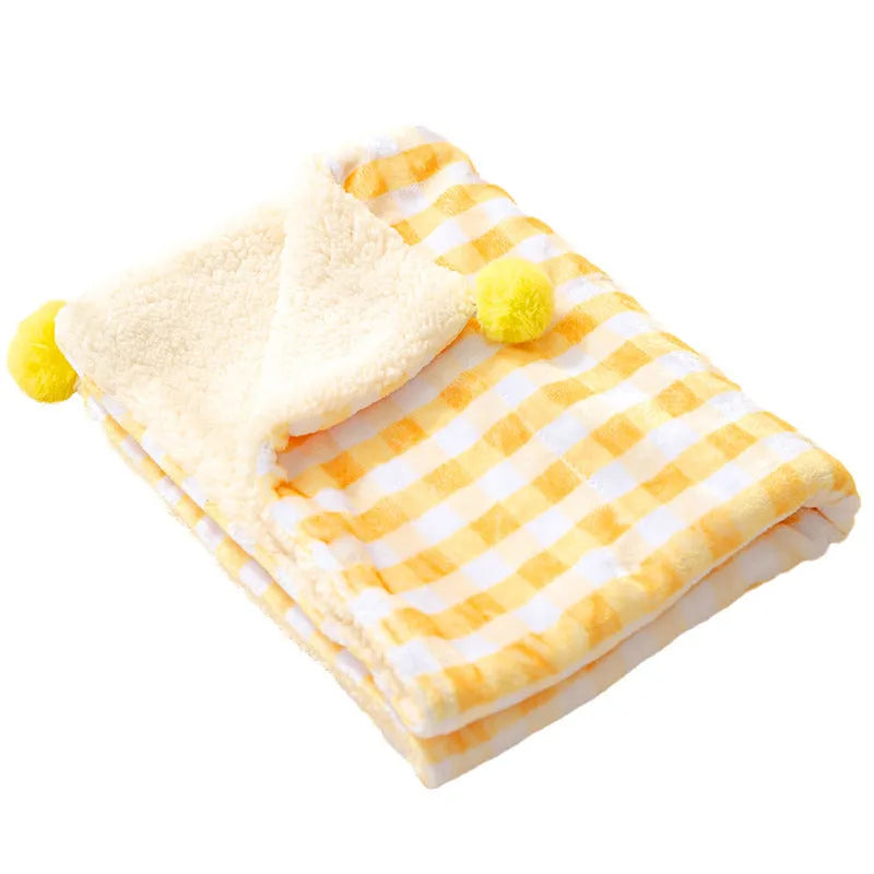 Thickened coral fleece dog blanket in blue, size 70x50cm, on a wooden floor