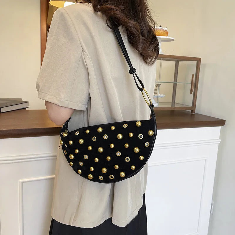 Retro rivet shoulder bag in frosted imitation buckskin with single strap and sewing line detail on a white background