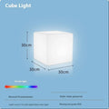 White square LED cube light stool on grass, showing modern design and waterproof build for outdoor use.
