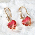 Pair of women's heart-shaped earrings made from blue coloured glass crystal.