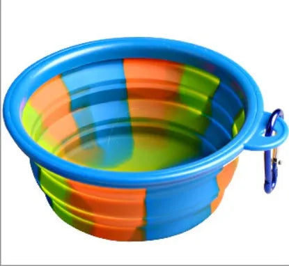 Collapsible silicone dog bowl in camouflage pattern folded flat on green surface