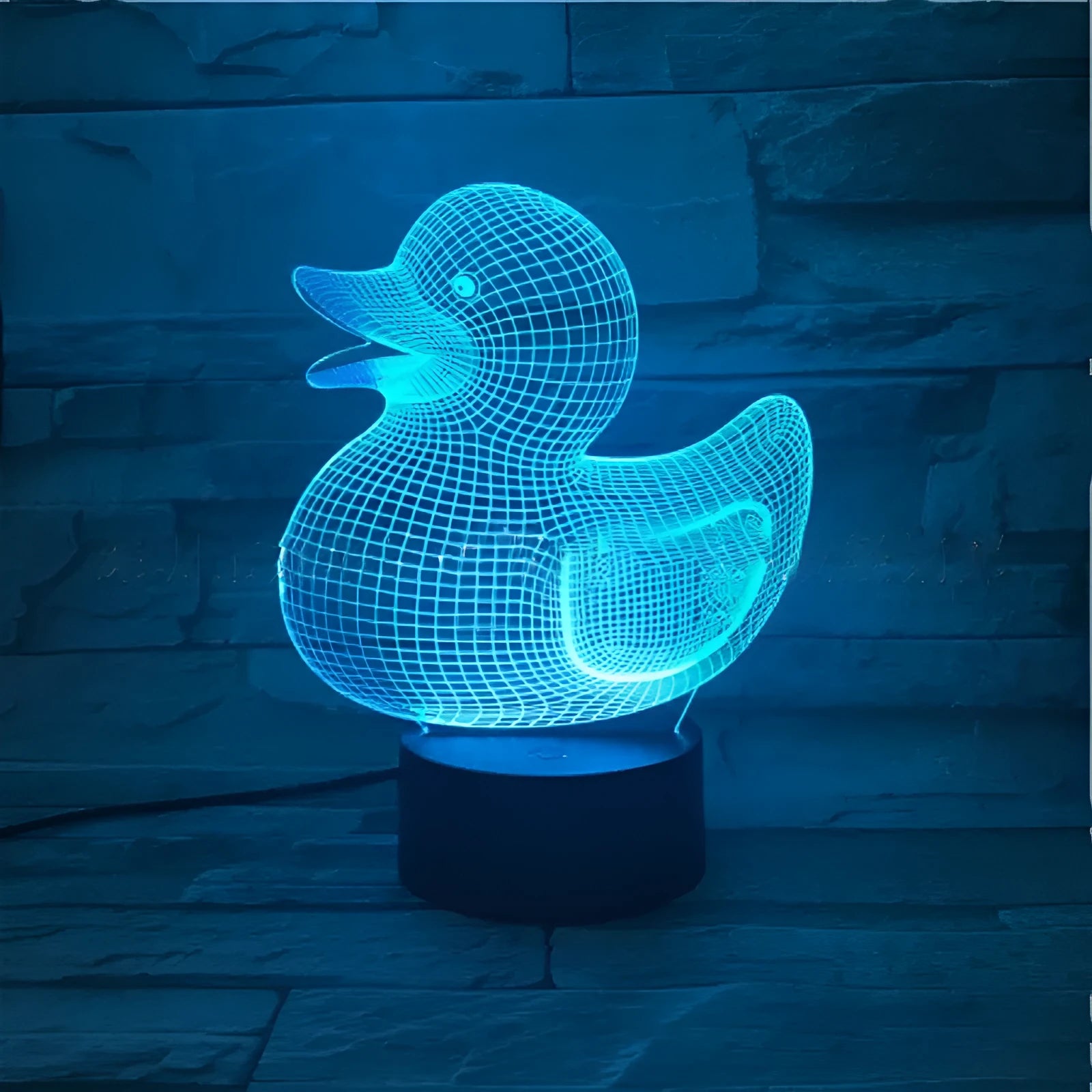 3D yellow duck shaped LED night light with remote control on a table