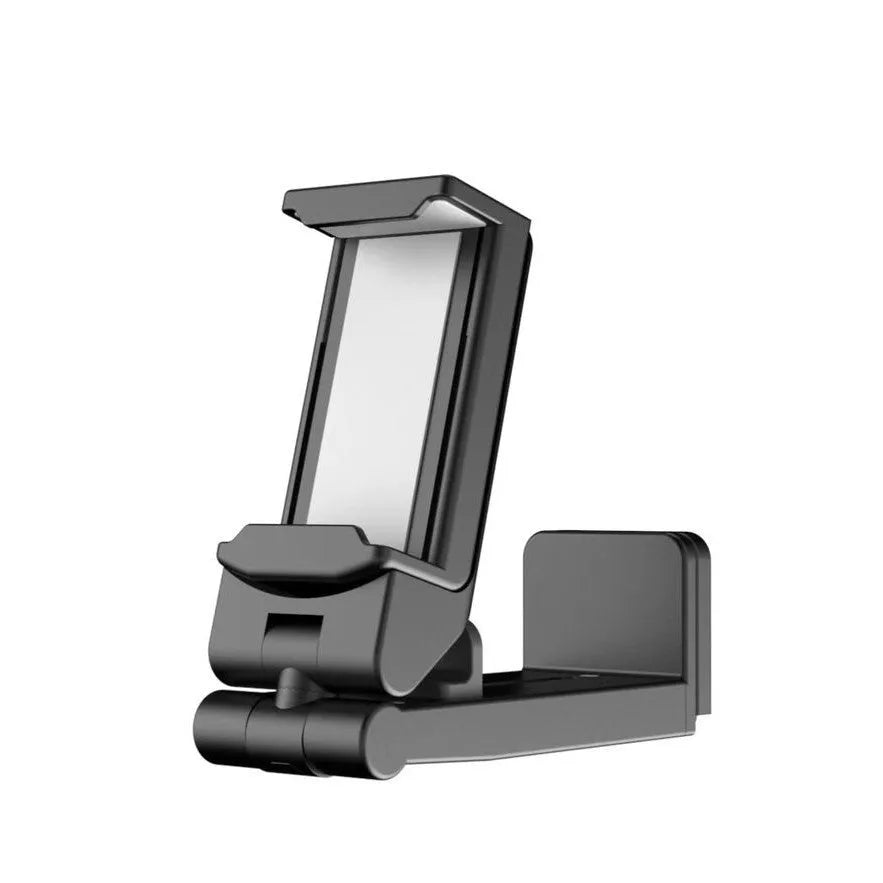 Black foldable rotating universal phone holder made of ABS plastic on a table.