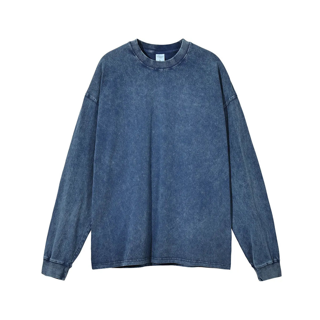 Man wearing a loose-fit, long-sleeve batik-effect cotton pullover in a washed vintage style.