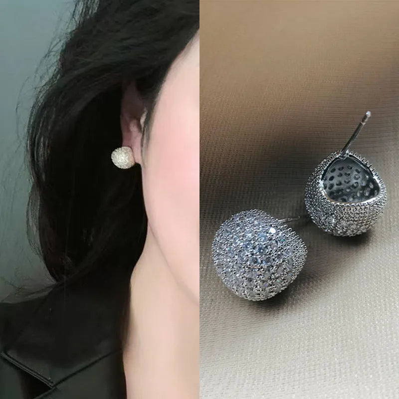 Geometric drop-shaped earrings with full diamond detailing, spherical elements, and little golden beans motif in gold or white colour
