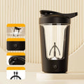 400ml electric protein shaker bottle in black with white lid and USB charging cable on a grey surface