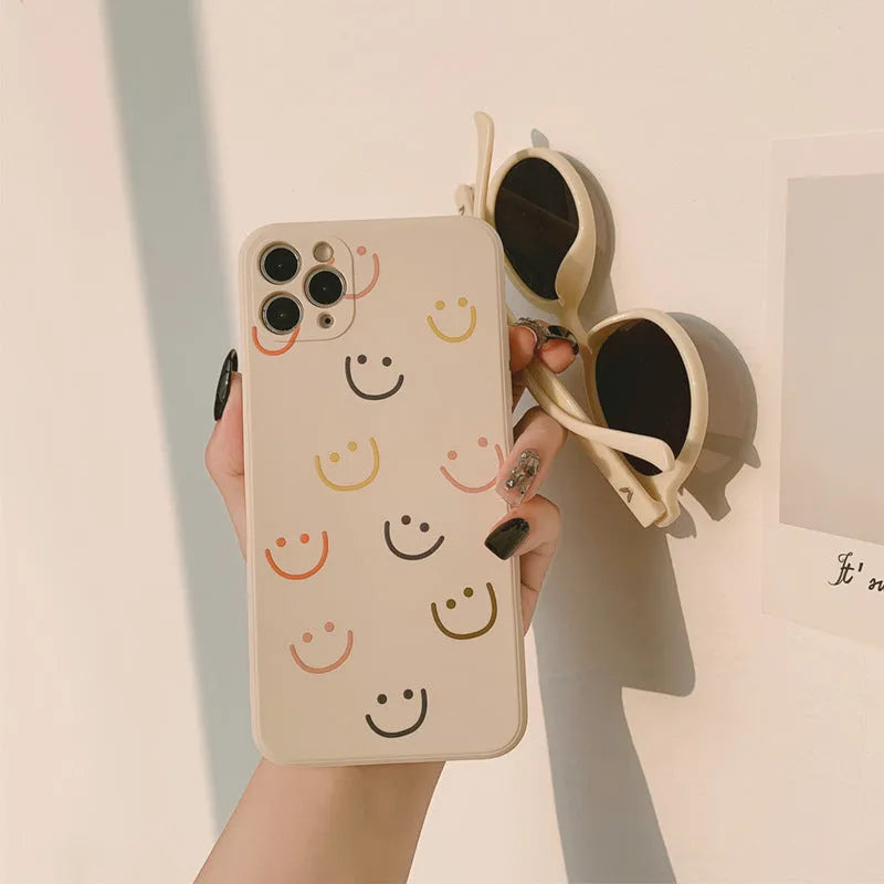 Simple silicone iPhone case with smiley face design in multiple colour options