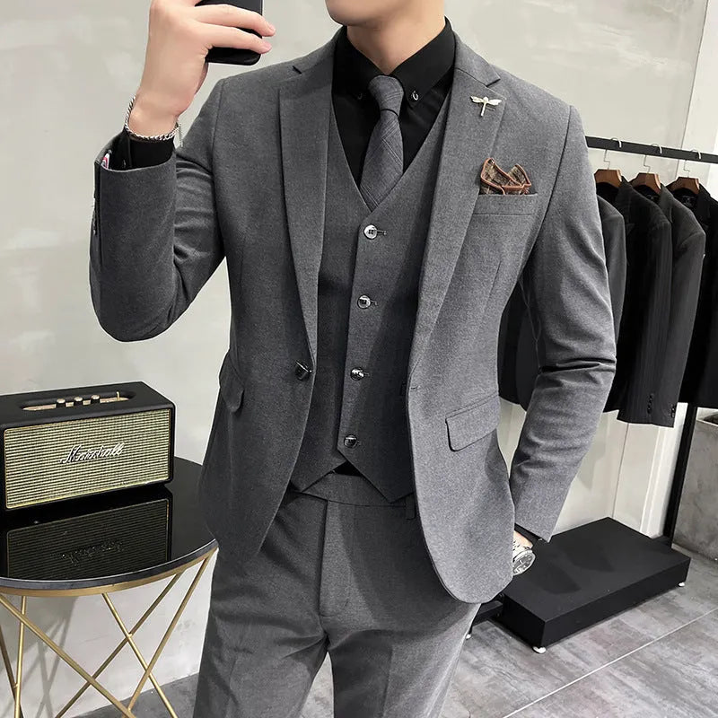 Three-piece men's acetate fibre blend business suit set in light gray with jacket, trousers, and vest.