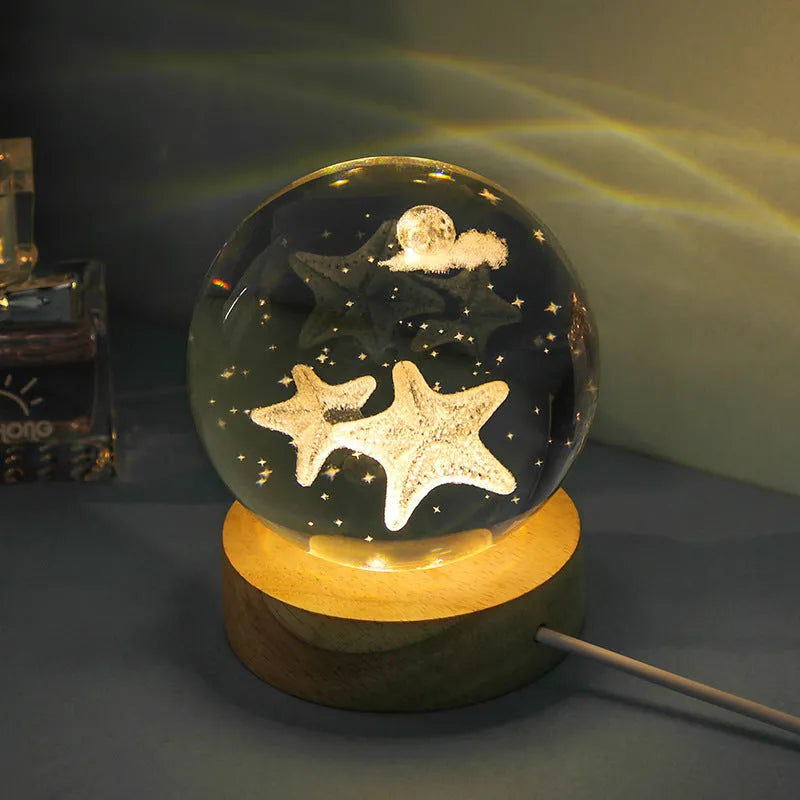 Transparent crystal ball night lamp with 3D carved jellyfish design, on a round base with USB cable.