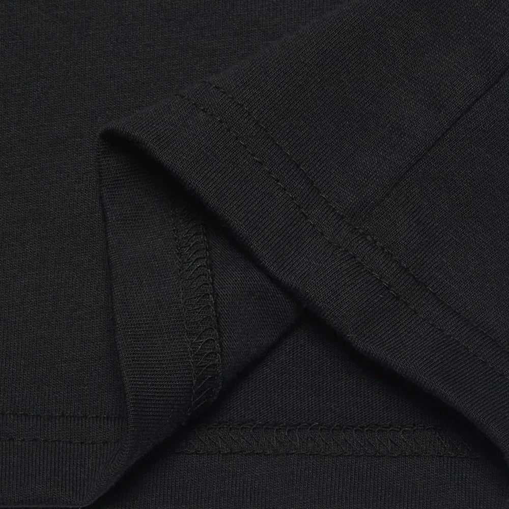 Funny Obedient And Reproducible text printed on a loose fit black cotton t-shirt.