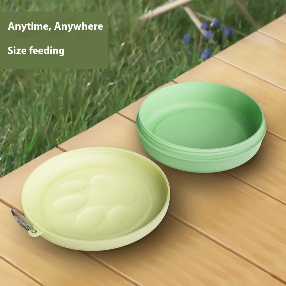 Collapsible silicone dog feeding bowl with lid shown in a green colour.