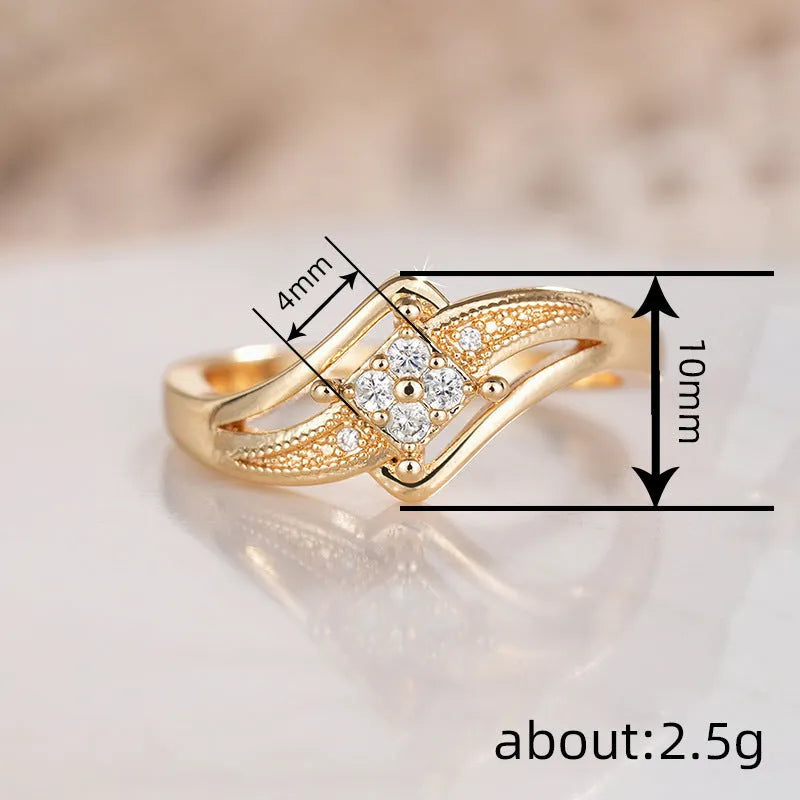Yellow gold women's geometric diamond ring with a small inlaid zircon stone, shown on a copper band.