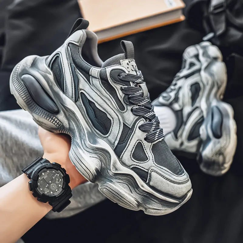 Men's black and white mesh sneakers with a platform sole and lace-up front on a plain background.