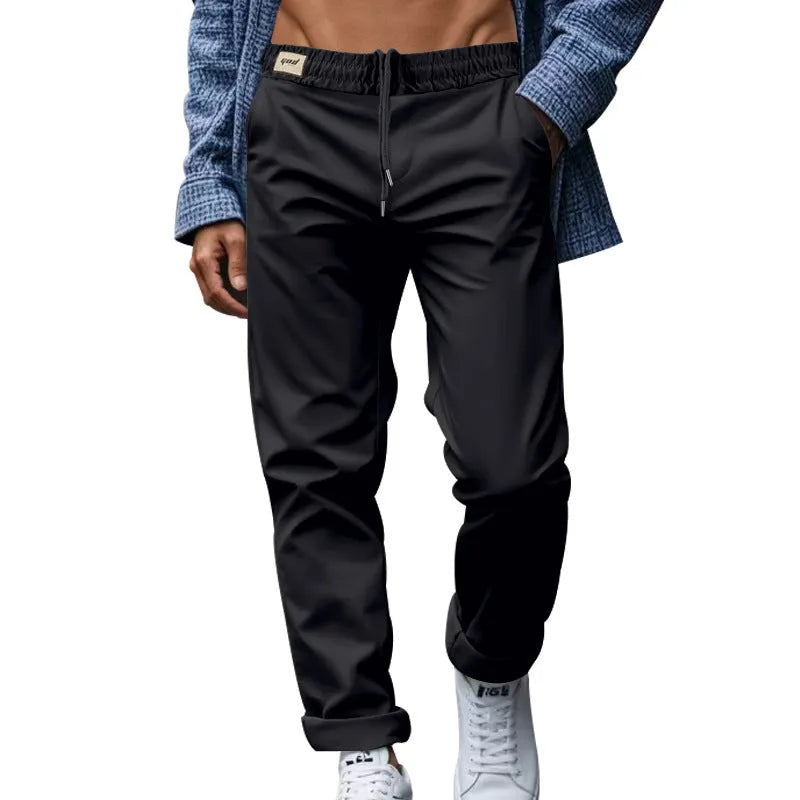 Men's casual trousers in solid grey, loose fit with drawstring waist and side pockets, full length