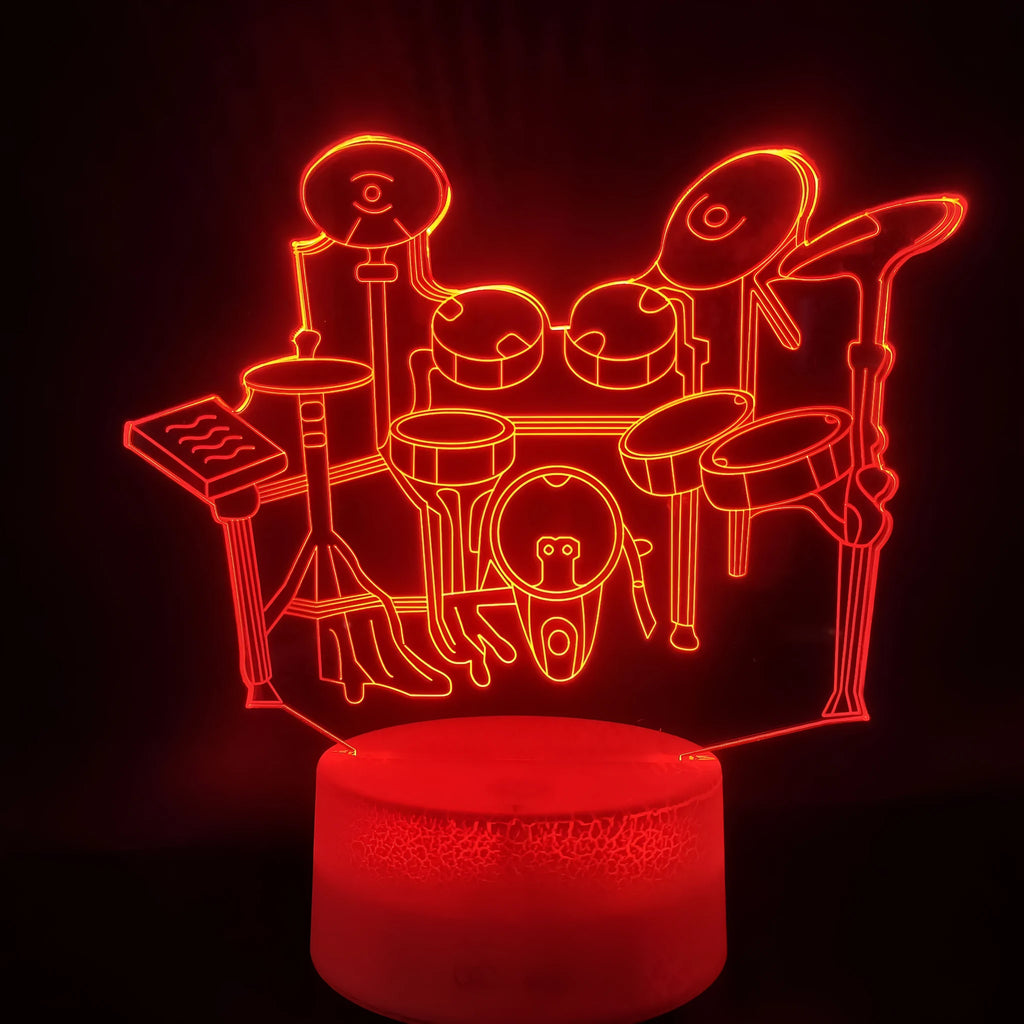 Drum kit shaped 3D LED night light with colourful illumination on a dark surface.