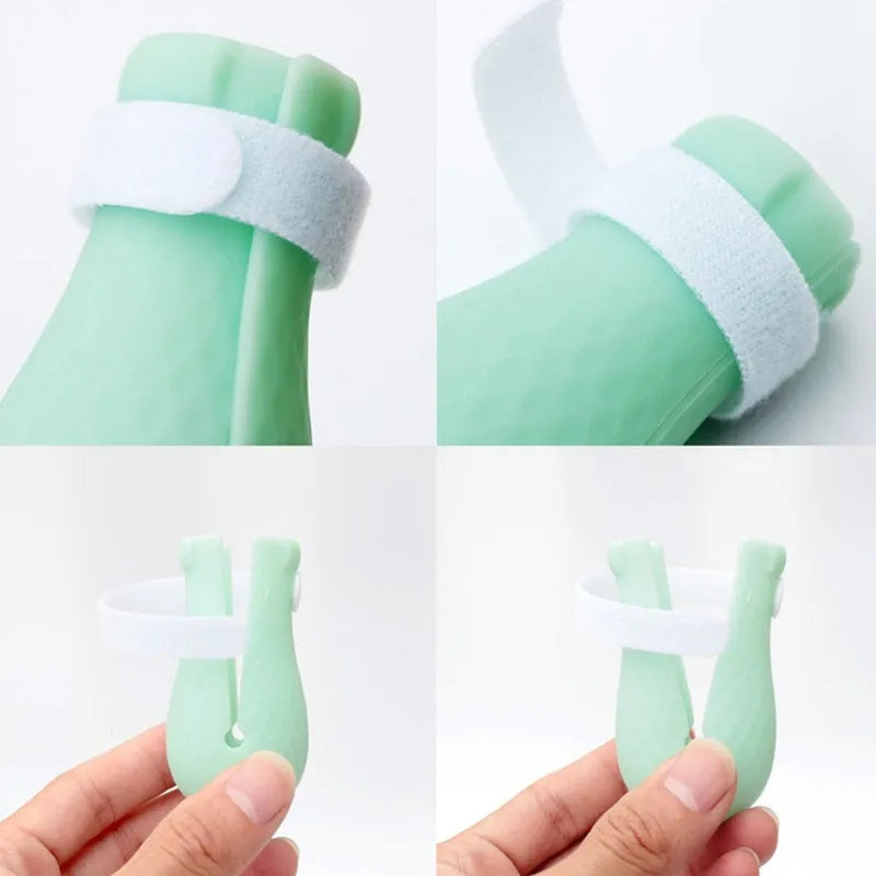 Green silicone cat foot covers with nylon buckle strap and leak hole design, set of 4 pieces on a white background