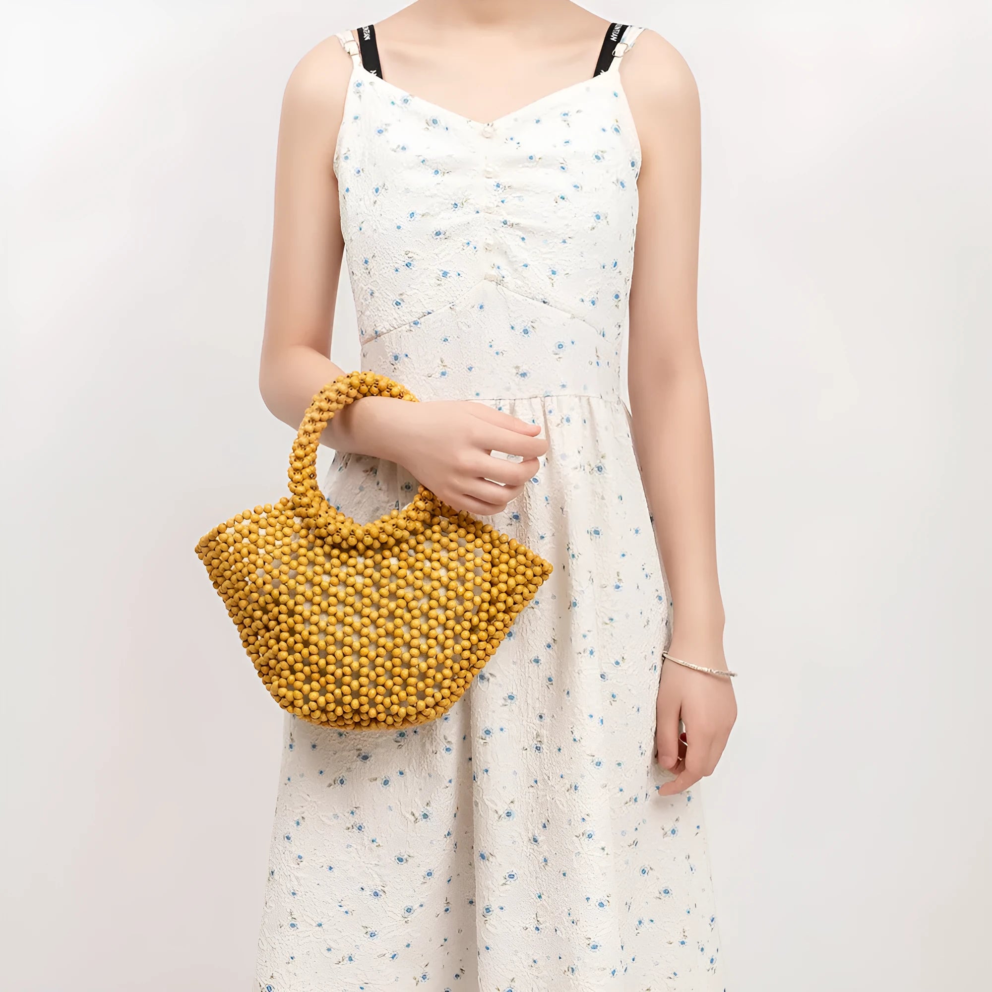 Hand-woven dumpling-shaped maple beach handbag with wooden bead decoration in milky white colour
