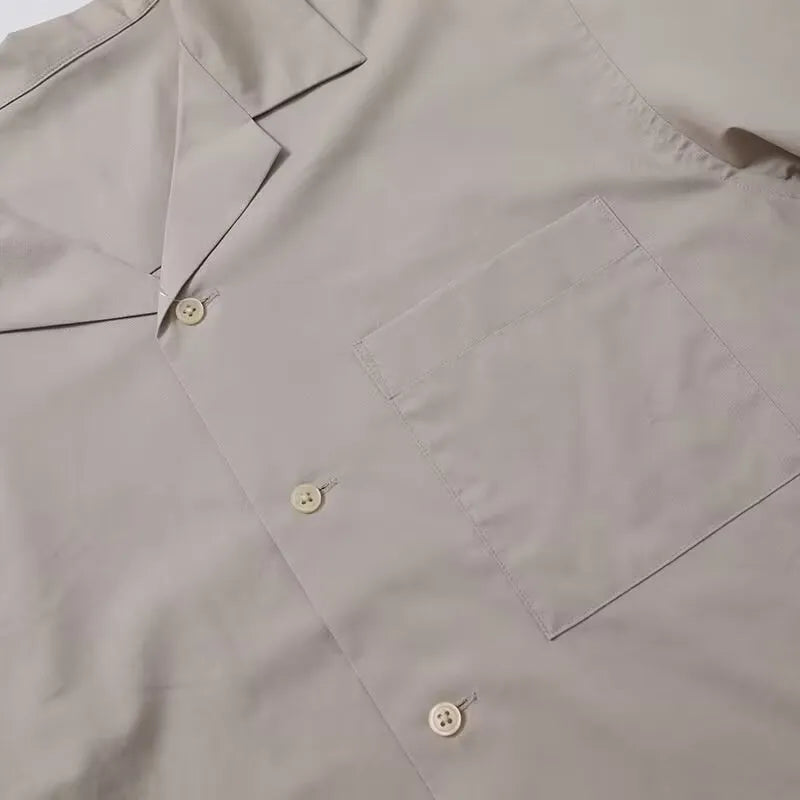 Men's and women's open collar solid colour shirt in beige with half sleeves and front pocket, loose fit