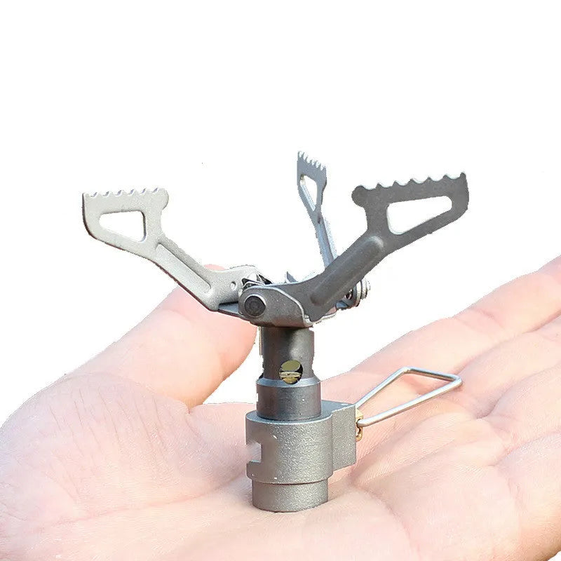 Compact portable propane gas camping stove with one-piece steel body and cast iron burner.