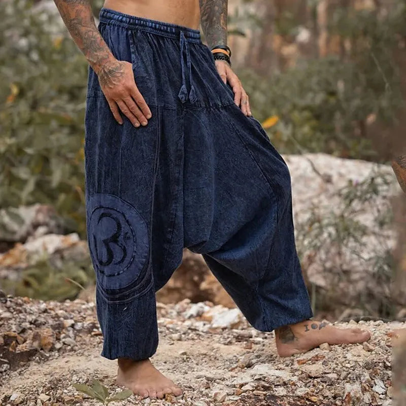 Men's dark green ethnic pattern casual ankle-tied trousers on model, polyester fabric