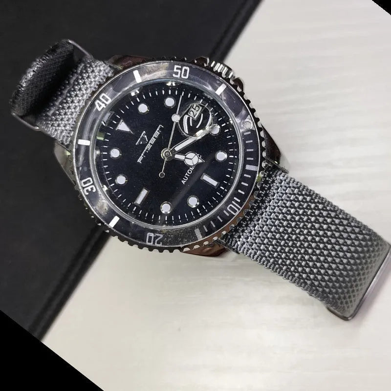 Nylon integrated watch strap in army green colour, showing the textile weave and buckle.